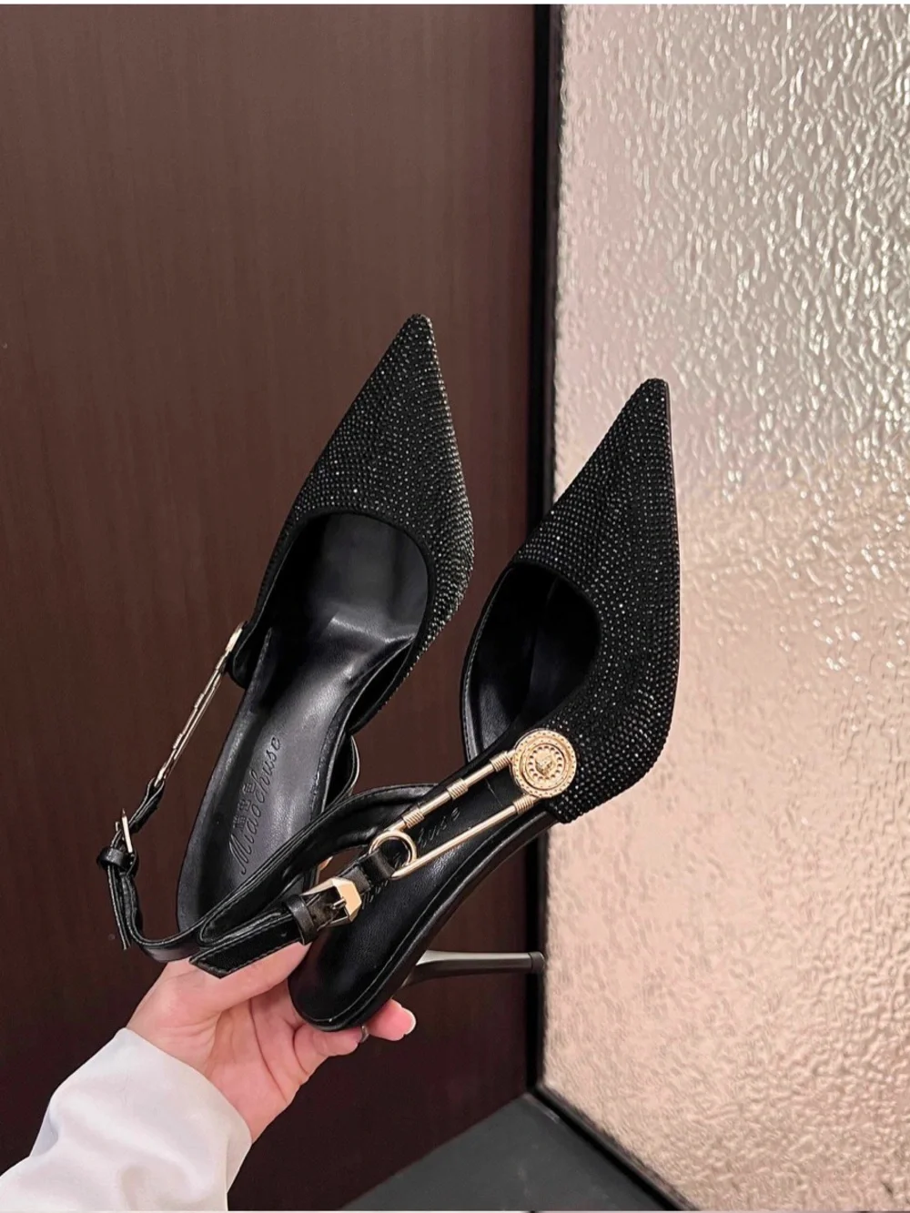 A Classy ChicBlack Rhinestone Pointed Slingback Pumps with Gold Accent.